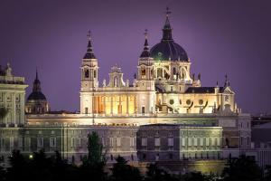 a large building lit up at night at La Casita de Loren in Madrid