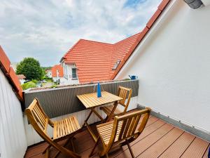 a table and two chairs on a balcony at Fewo II Graal-Müritz Sobierajczyk in Graal-Müritz