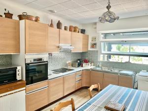 a kitchen with wooden cabinets and a table in it at Maison Basque in Biarritz