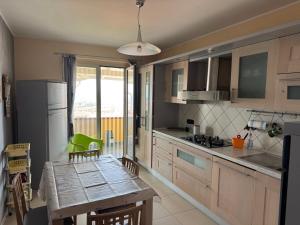 una cucina con tavolo e frigorifero e una sala da pranzo di Il Belvedere Guest House a Scalea Altre 21 foto