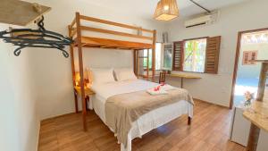 a bedroom with a bed and a bunk bed at Che Brazil Pousada in Cruz