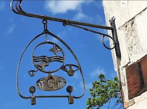 a metal sign on the side of a building at Maison de la radio Espace Philips in Sancerre +5 photos