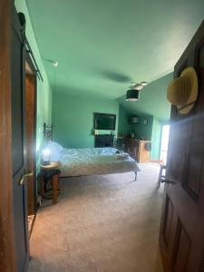 a bedroom with a bed and a television in it at Explorer Room Ensuite Mountain View 3rd floor in Pwllheli