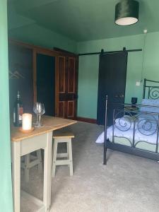 a room with a table and a bed at Explorer Room Ensuite Mountain View 3rd floor in Pwllheli +6 photos