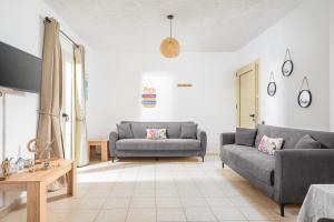 a living room with two couches and a table at Ocean in Hersonissos
