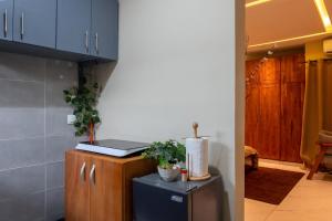 a kitchen with blue cabinets and a blue refrigerator at Maison Kéfi in Bingerville