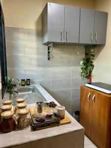 a kitchen with a sink and a counter top at Maison Kéfi in Bingerville +9 photos