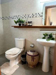 a bathroom with a toilet and a sink at Maison Kéfi in Bingerville