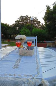 a table with two wine glasses on a table at Villa Annarè in Martina Franca