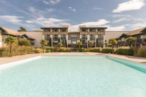 una gran piscina frente a un edificio en Residence Moliets - maeva Home, en Moliets-et-Maa