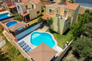 an aerial view of a house with a swimming pool at Ocean in Hersonissos