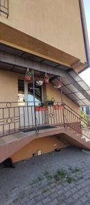 a balcony of a building with potted plants on it at Blue Butterfly Apartment - Cozy and Stylish Stay in Sibiu