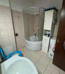 a small bathroom with a toilet and a sink at Blue Butterfly Apartment - Cozy and Stylish Stay in Sibiu +30 photos
