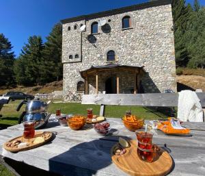a table with food on it in front of a building at Kulla Guest House in Peje