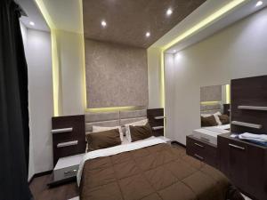 a bedroom with a large bed and a mirror at Modern 3 bedroom Penthouse in Cairo