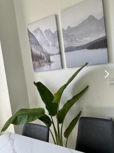 a plant in a room with two pictures on the wall at Beautiful Villa in Shanhua