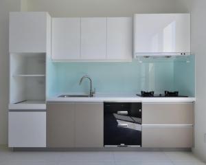 a kitchen with white cabinets and a sink at Beautiful Villa in Shanhua