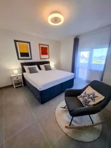 a bedroom with a bed and a chair in it at Apartments Davor in Drage