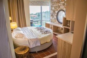 a bedroom with a bed in a room with a window at Kallisti Hotel in Potos