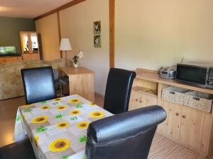 a dining room with a table with sunflowers on it at Ferienwohnung Mario Jank Calau in Calau