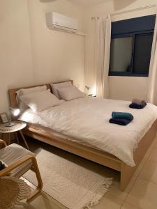 a bedroom with a bed with two towels on it at The old Oak tree by the Banias river in Kibbutz Snir