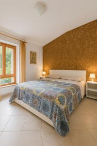 a bedroom with a large bed and a wall at Nido Alpino - by Lucia vacanze 13 in Folgarida