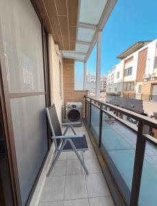 a chair sitting on the balcony of a building at Beautiful Villa in Shanhua