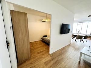 an open door to a living room with a table at Loft Moderne climatisé centre ville in Valence +5 photos