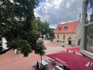 a street with a red umbrella and a building at Helmstedt City Apartment in Helmstedt