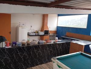 a kitchen with a counter top with a refrigerator at Hotel e Pousada Liberdade in Ouro Preto