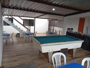 a pool table in a room with chairs and a staircase at Hotel e Pousada Liberdade in Ouro Preto