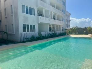 a swimming pool in front of a building at Luxury Penthouse 7 Islands View at Ocean Pearls in Watamu