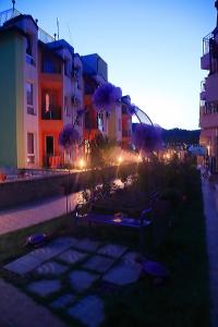 a view of a street with buildings at dusk at PoolView Elite Apartment in RoseGardenComplex with BigPool and Parking in Balchik