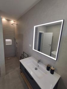 a bathroom with a white sink and a mirror at Apartments Davor in Drage +61 photos