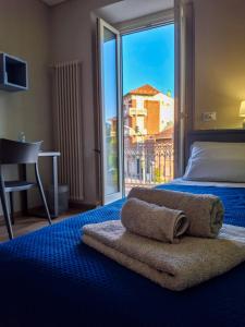 Un dormitorio con una cama y una ventana grande. en Casa del corso, en Collegno