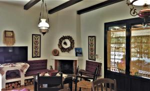 a dining room with a table and a fireplace at Gianni's village home in Aegina Town