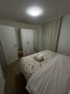 a bedroom with a white bed and a white cabinet at Relaxed Getaway by the Sea in Trogir