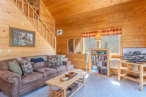 a living room with a couch and a table at The Aspen House in West Yellowstone