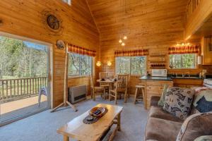 a living room with a couch and a table in a cabin at The Aspen House in West Yellowstone