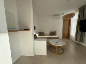a living room with a table and a couch at Antiparos Gems in Agios Georgios