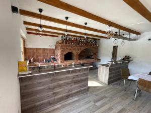 a kitchen with a counter and a brick fireplace at Una Dreams in Bare