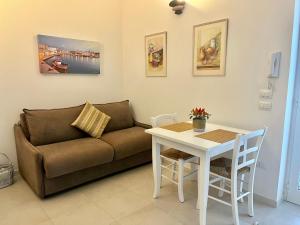 a living room with a couch and a table at Villa Costa del Sole - Capitolo in Monopoli