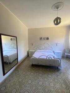 a bedroom with a bed and a large mirror at A casa di Rita in Toro