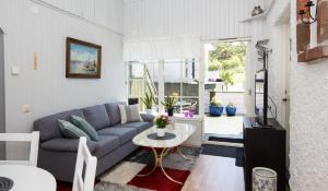 a living room with a blue couch and a table at Kajan in Strömstad