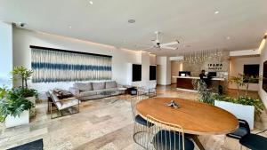 a living room with a table and a couch at Ipana Luxury Suites By Caribe Rentas in Playa del Carmen