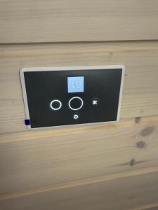 Un termostato en una pared de madera de una habitación. en Happy Mermaid Garden Cabin, en Aalborg