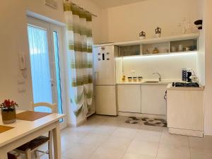 a kitchen with a sink and a refrigerator at Villa Costa del Sole - Capitolo in Monopoli