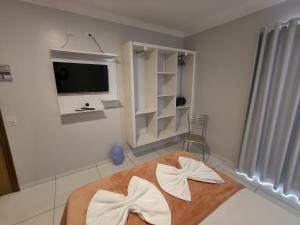 TV a/nebo společenská místnost v ubytování Hotel Vitória - Guaíra