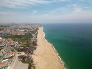 an aerial view of a beach and the ocean at Casa De Sousa-Refúgio de Surf entre Peniche e Ericeira in A dos Cunhados