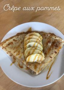 a plate of pancakes with sliced bananas on it at Le CLOS D'ETRETAT in Les Loges